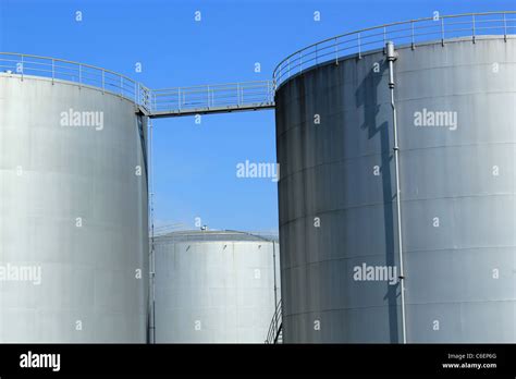 Big Grey Oil Tanks And Blue Sky Stock Photo Alamy