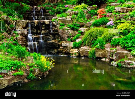 Cascading waterfall and pond in japanese garden Stock Photo - Alamy