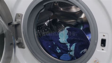 A Girl Puts Dirty Things In The Washing Machine Close Up Stock Video