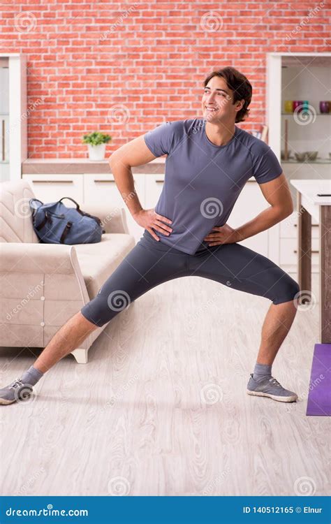 The Young Handsome Man Doing Sport Exercises At Home Stock Image Image Of Keeping Attractive