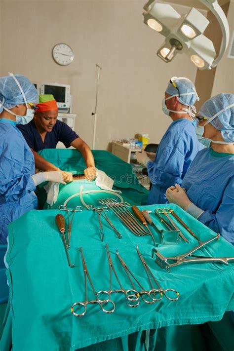 Laid Out For Life Saving Surgery A Team Of Surgeons Performing A