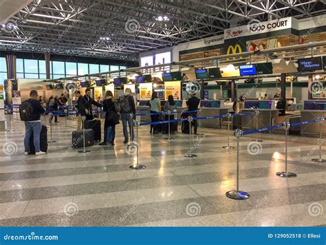 Passengers Lined Up For Chek-in Inside The Milan-Malpensa Airport Terminal 1. Editorial Photo ...