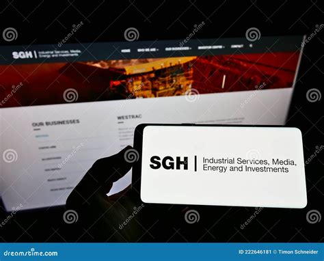 Person Holding Cellphone With Logo Of Australian Company Seven Group