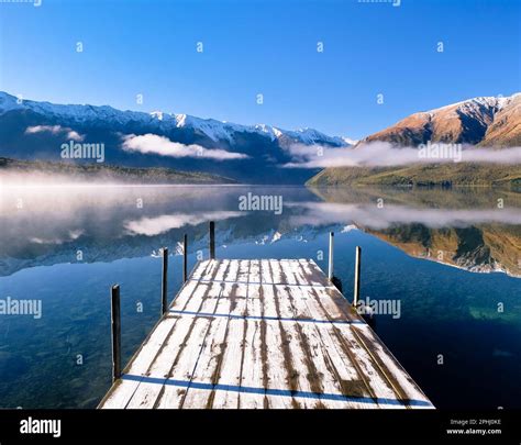 Dock And Mountains Reflected In Lake Rotoiti Nelson Lakes National