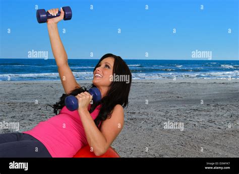 Woman Standing On The Beach Doing A Workout Stock Photo Alamy