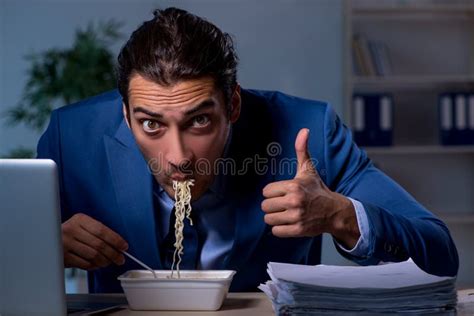 Hungry Employee Working Late In The Office Stock Photo Image Of