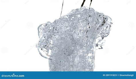 Water Being Poured Into Glass Against White Background Stock Image