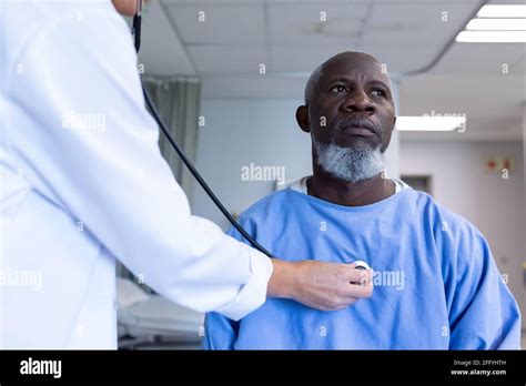 Caucasian Female Doctor Examining With Stethoscope African American