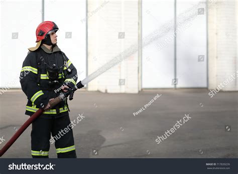 Fireman Holds Adjust Nozzle Fire Hose Stock Photo Shutterstock