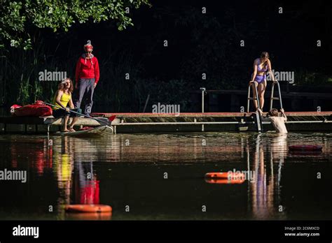 Swimmers Enter The Hampstead Heath Mixed Bathing Pond In London As It