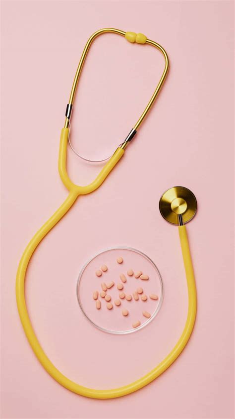 Download Yellow Stethoscope Pink Pills Pink Background Wallpaper