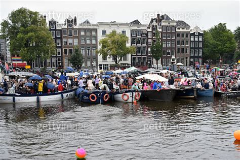 People Standing On Tour Boat During Amsterdam Gay Pride Canal Parade