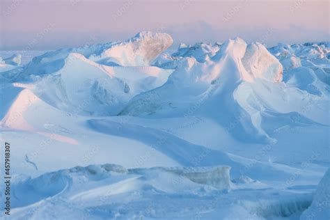 Winter arctic landscape. View of snow and ice at sunset. Ice hummocks ...