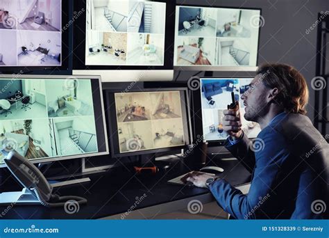 Security Guard Monitoring Modern Cctv Cameras In Surveillance Room