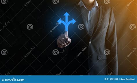 Businessman In A Suit Holds A Sign Showing Three Directions In Doubt