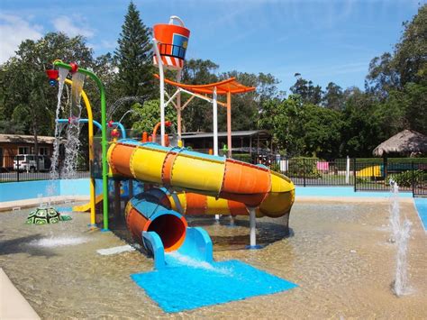 A Water Park With A Slide And Splash Pool