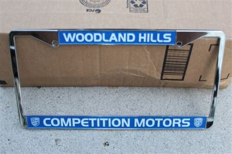 Competition Motors Por Dealership License Plate Frame Blue Metal New