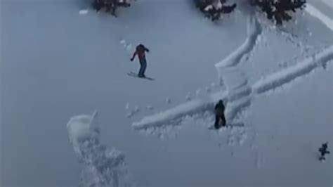 Skier Nearly Avoids Photographer On Cliff Landing Watch