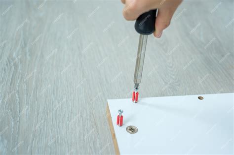 Premium Photo Man Using Screwdriver Assembling Or Repairing Furniture