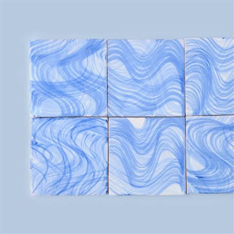 Blue And White Marble Tiles With Wavy Lines In The Middle On A Light