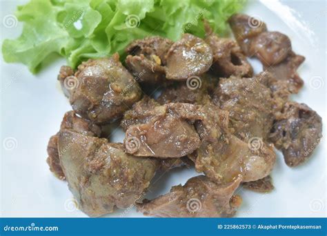 Fried Chicken Liver And Gizzard With Pepper Couple Garlic On Plate