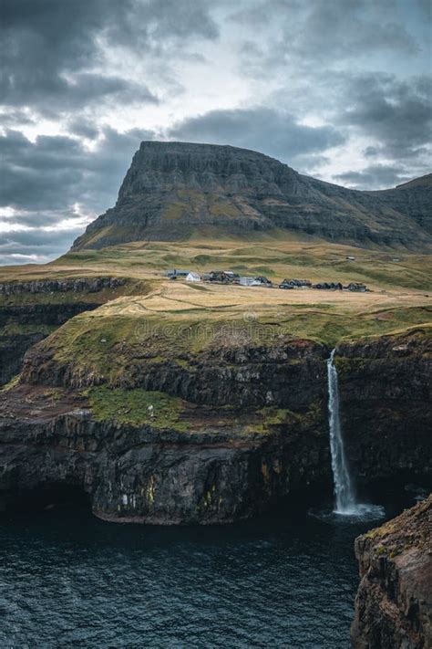 Gasadalur Village And Mulafossur Its Iconic Waterfall During Sunset In