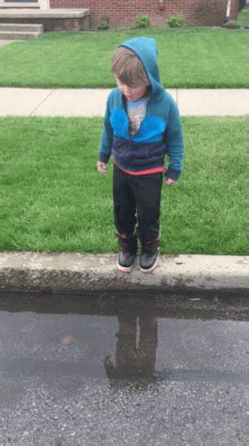 Jump Jumping Puddles GIF - Jump Jumping Puddles Kid - Discover & Share GIFs