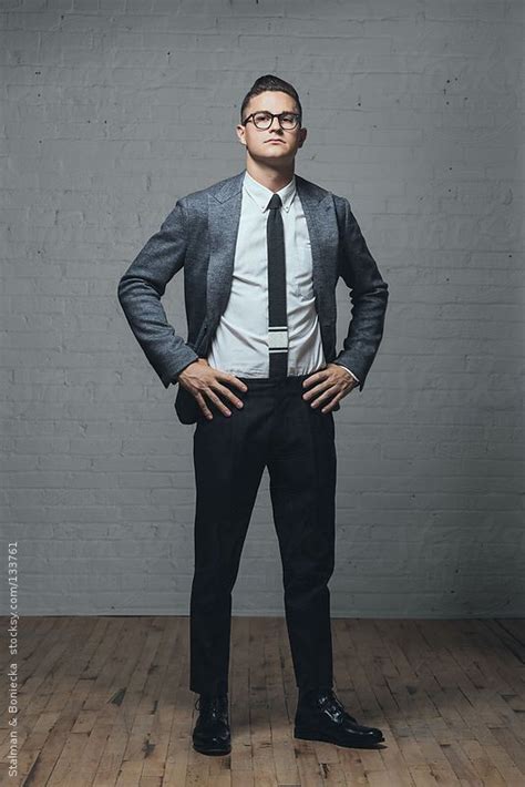 A Young Man Standing In Studio With Hands On Hips By Stocksy