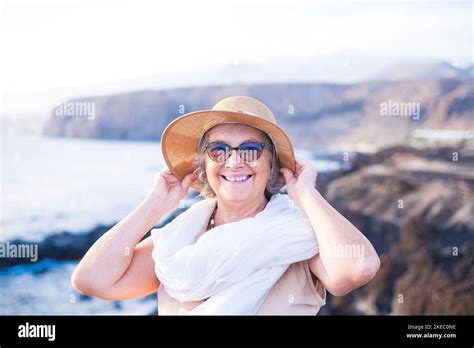Portrait Of Mature Woman Smiling And Looking At The Camera Holding Her