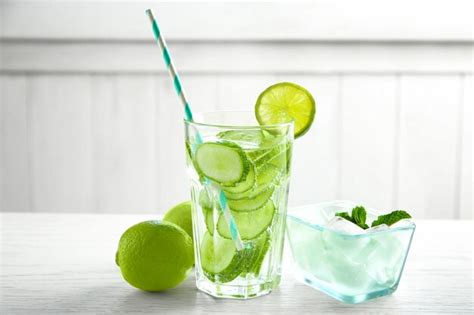 Premium Photo Delicious Refreshing Water With Cucumber In Glass On Table