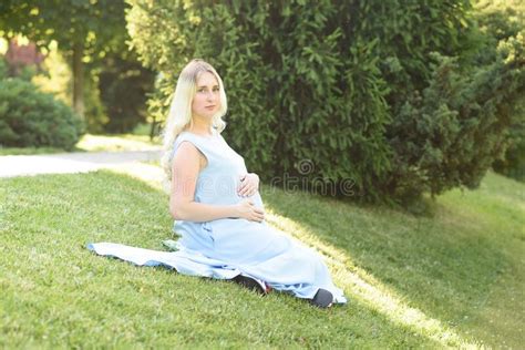 Beautiful Portrait Of A Pregnant Woman On A Warm Summer Day In The