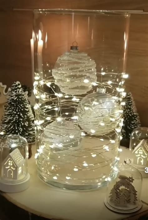 A Table Topped With Lots Of Glass Bowls Filled With Snow Globes And