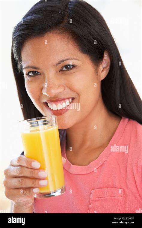 Mid Adult Woman Drinking Fresh Orange Juice Stock Photo Alamy