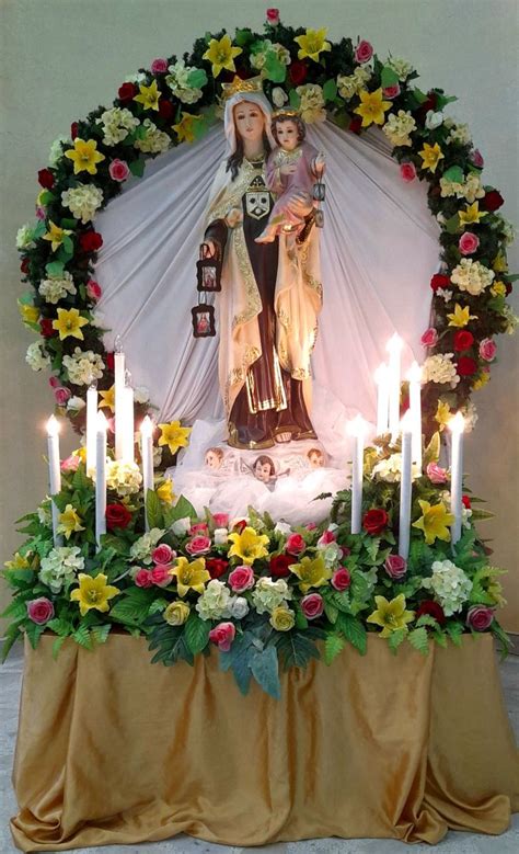 An Altar With Flowers And Candles In Front Of The Virgin Mary Statue On