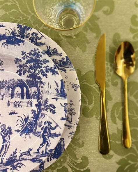 A Blue And White Plate Sitting On Top Of A Table Next To A Silver Fork