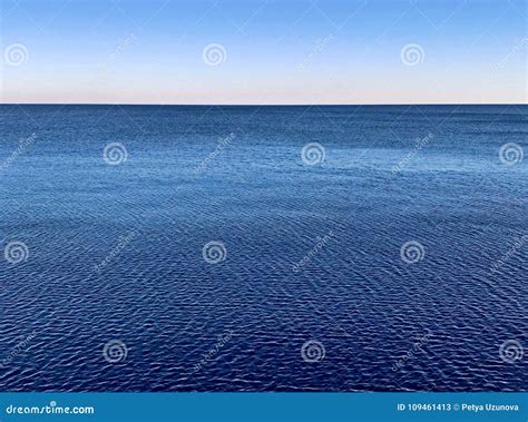 Minimalistic Water Surface With Blue Seascape Horizon And Clear