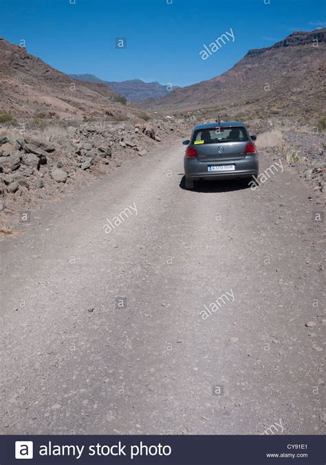 Arid Landscape With Vw Polo Car On Road At Veneguera Gran Canaria