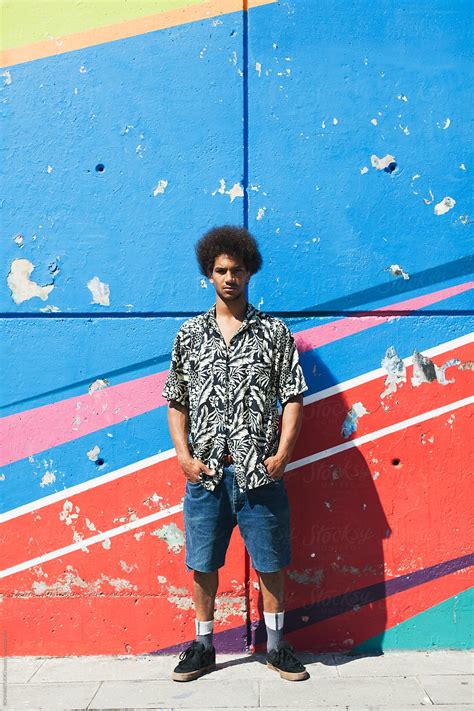 Portrait Of A Young Afro Man Standing In Front Of A Colourful Wall