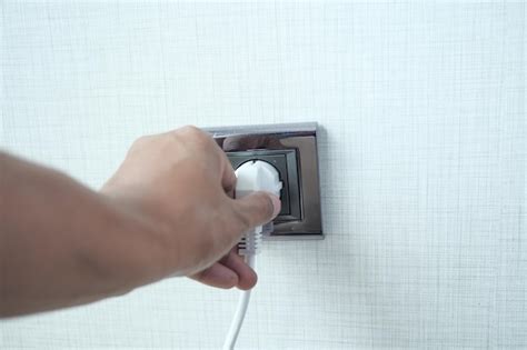 Premium Photo White Color Power Cord Cable Plugged Into Wall