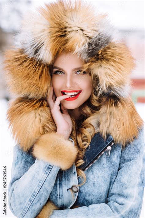 Beautiful Blonde Girl Posing In Winter Fur Coat In The Snow Stock Photo Adobe Stock