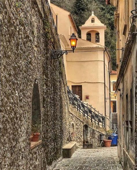 An Alley Way With Cobblestones And Stone Buildings