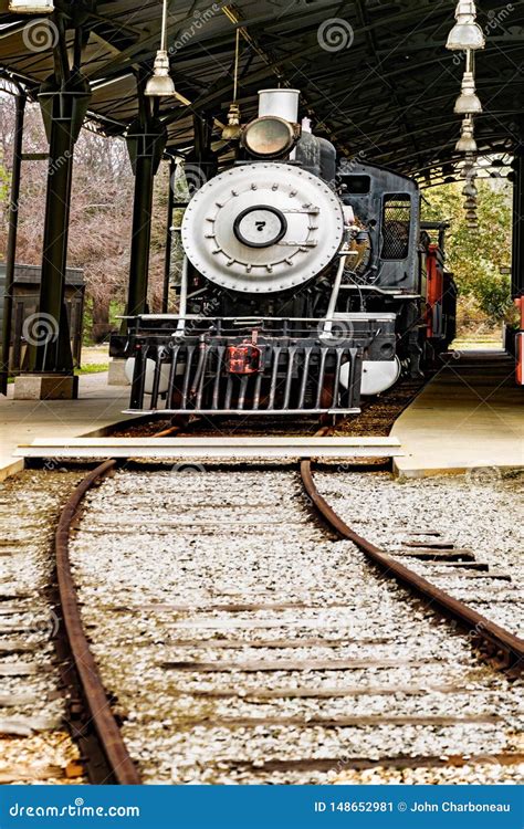 Vintage Coal Burning Steam Engine Locomotive Loading At The Station