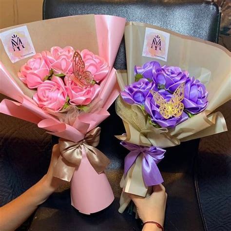 Two Bouquets Of Pink And Purple Flowers Are Sitting On A Black Leather