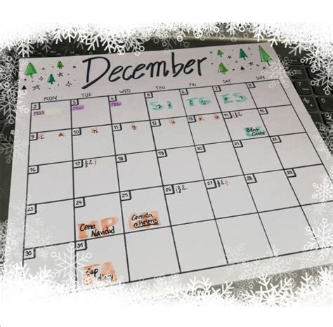 A Calendar With The Word December Written On It In Front Of Snowflakes