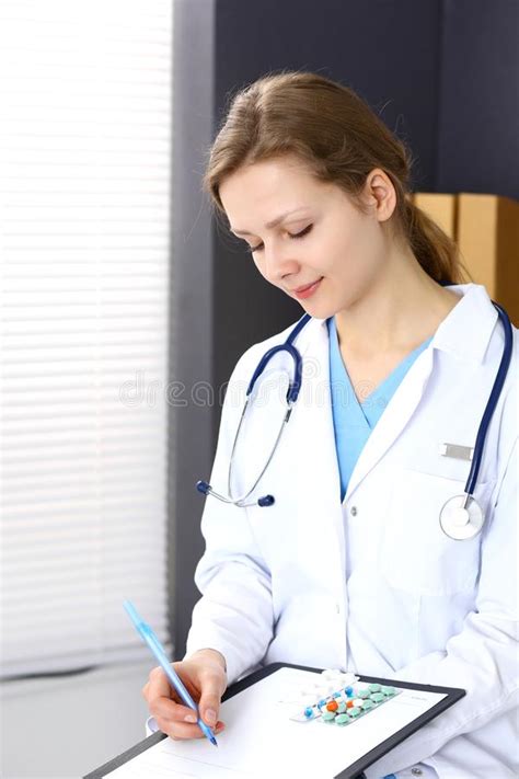 Woman Doctor At Work At Hospital Young Female Physician Write