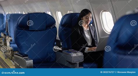 Businesswoman Flying And Working In An Airplane In First Class Man