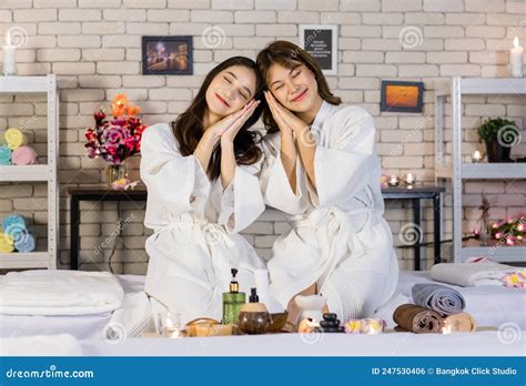 Portrait Shot Of Two Asian Young Beautiful Cheerful Female Spa Customers In White Clean Bathrobe