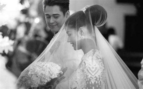 The Bride And Groom Are Looking At Each Other In This Black And White