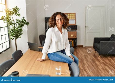 Middle Age Hispanic Woman Smiling Confident Wearing Glasses At Office