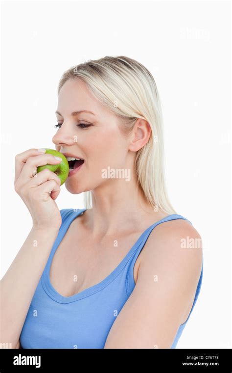 Beautiful Blonde Woman Eating A Delicious Green Apple Stock Photo Alamy